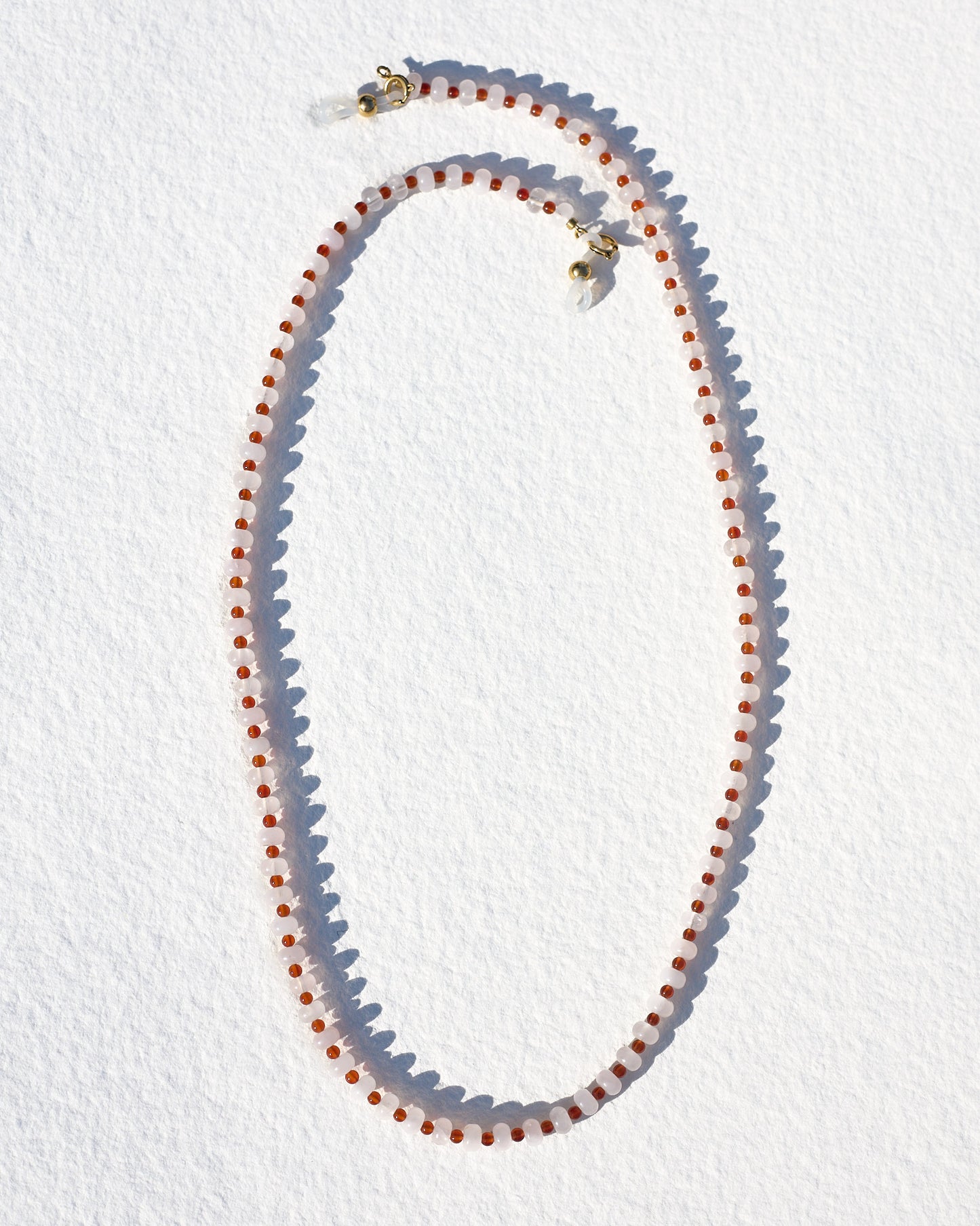 Necklace with red and white beads on a white background